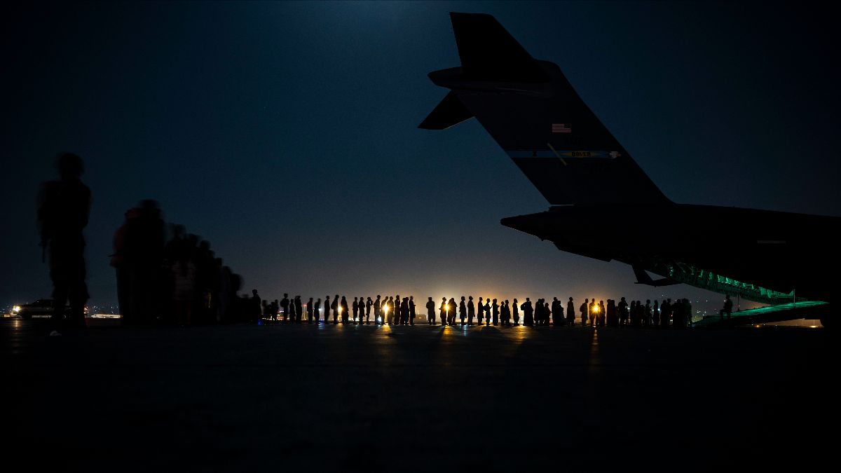 U.S. Air Force aircrew prepare to load evacuees aboard a C-17 Globemaster III aircraft  at Hamid Karzai International Airport in Kabul, Afghanistan, on Aug. 21, 2021. (Photo: U.S. Air Force / Senior Airman Taylor Crul)