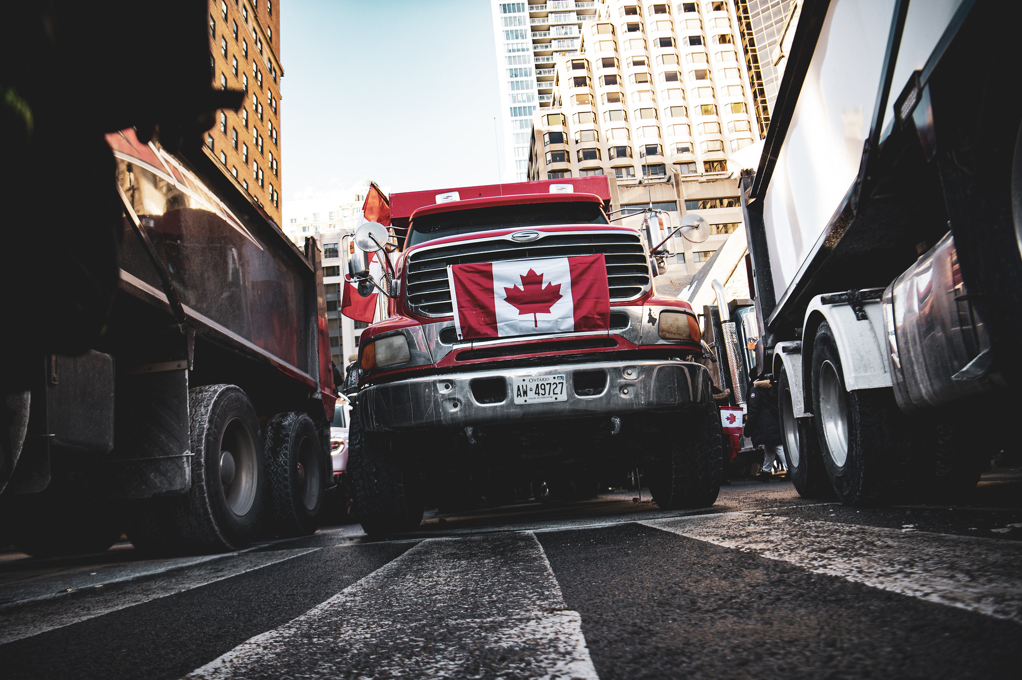 A truck with the Canadian flag over its grill blocks a street in Toronto