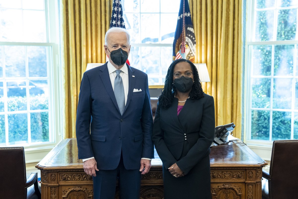 President Joe Biden and Supreme Court Justice nominee Ketanji Brown Jackson stand in the Oval Office in front of the desk.