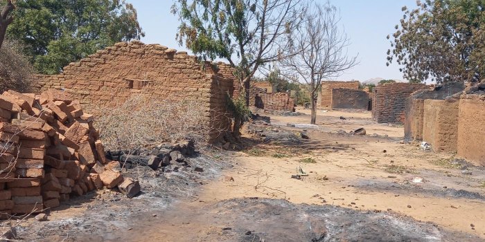 A photo of Kreinik in Sudan's West Darfur region. The photo was taken prior to recent attacks and shows buildings made of bricks and a dirt road.