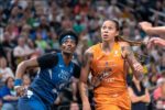 Britney Griner, right, prepares for a potential rebound. Her opponent is a Minnesota Lynx player. Griner is in Phoenix Mercury orange. The Lynx player wears blue.