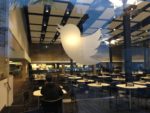 A mostly empty Twitter cafeteria with a logo stenciled onto glass.