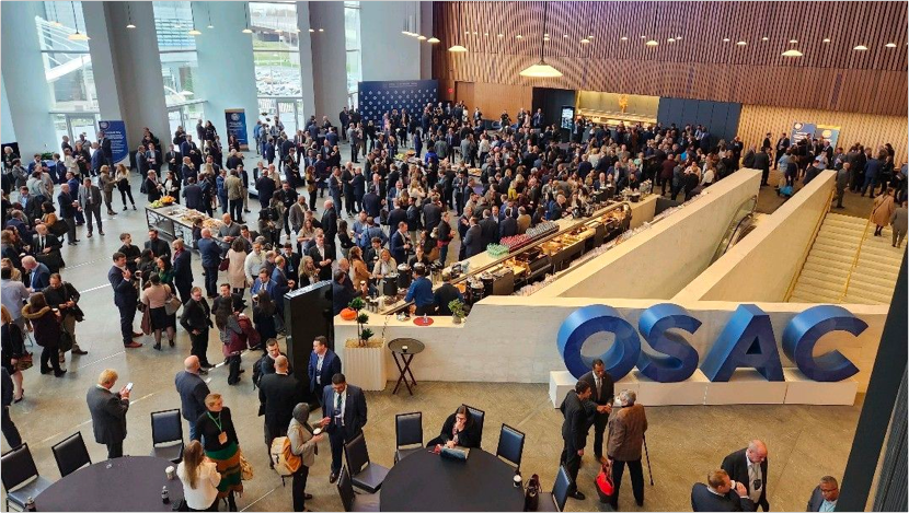 Image from OSAC 2022. The crowd is large with maybe 300 people seen from two floors above them