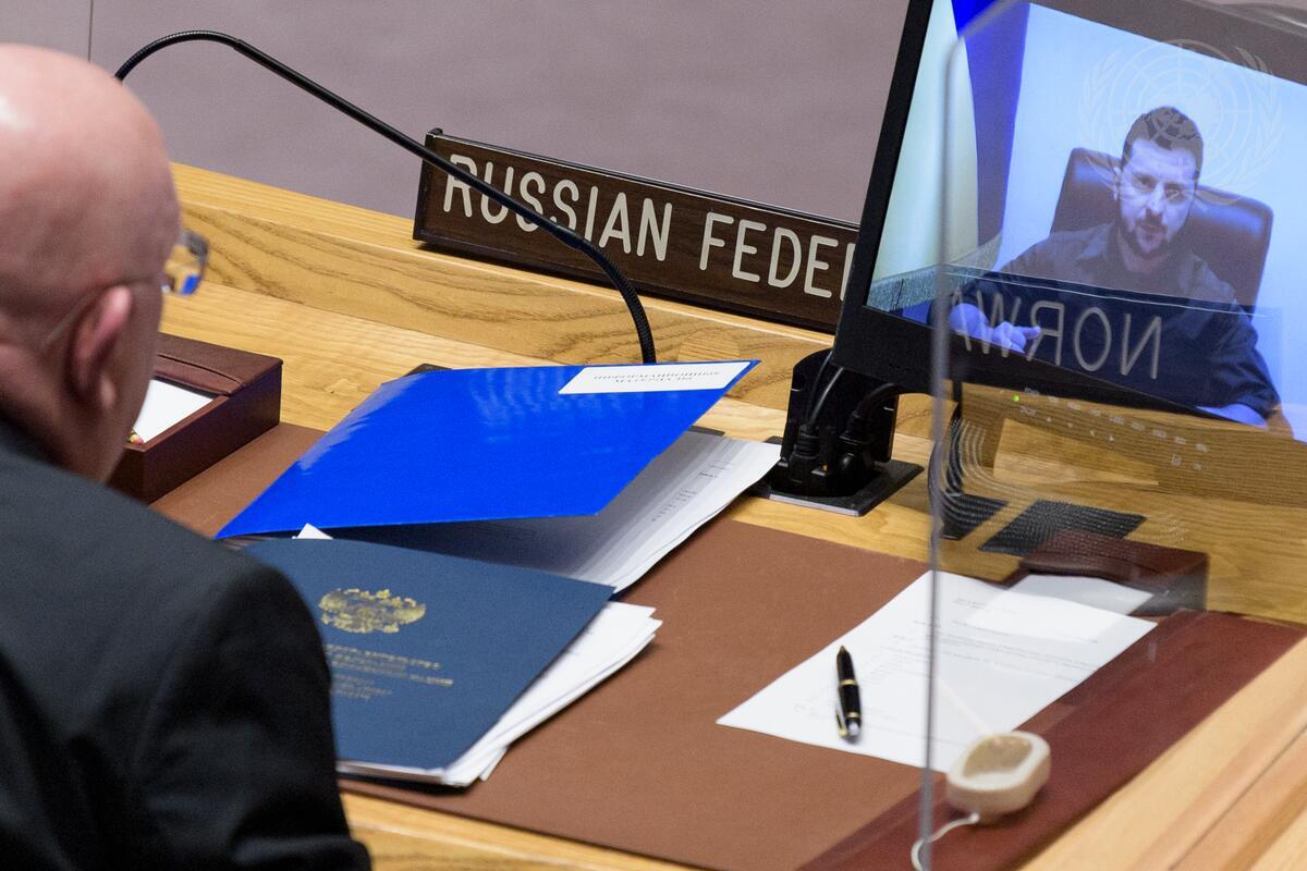 A photo over Vassily Nebenzia, Russia's Security Council representative, shoulder as he watches Ukraine's leader speak about the Russian invasion of Ukraine.