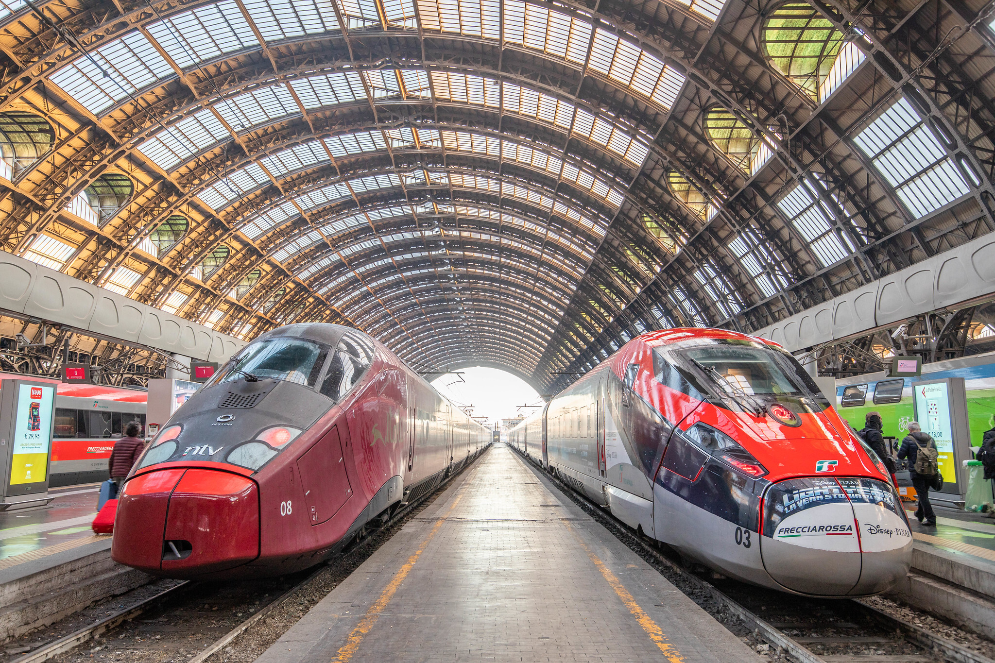 Two sleek trains inside the central station in Milan