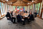 The eight leaders of the G7 in June 2022 sit circling a round table. Joe Biden of the United States is the most prominent in this photo.