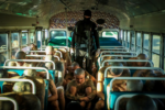 Inside a bus with dozens of shaved-headed prisoners and just one guard in the aisle