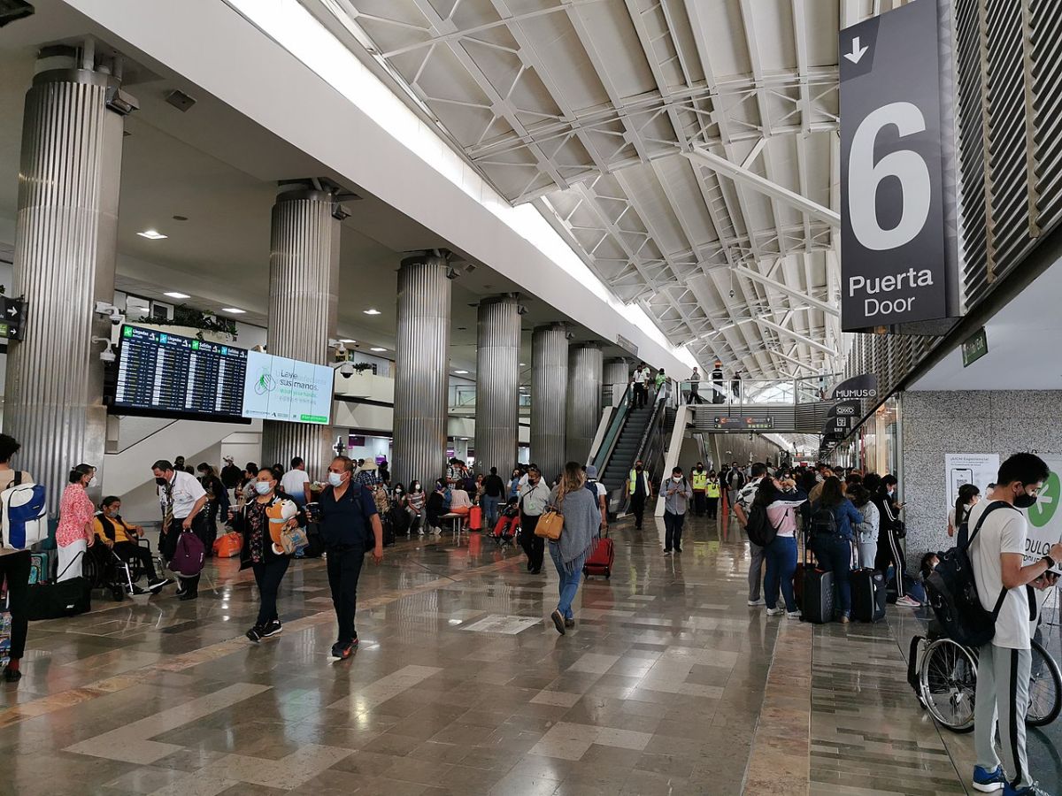 People walk through a terminal in Mexico City International Airport.