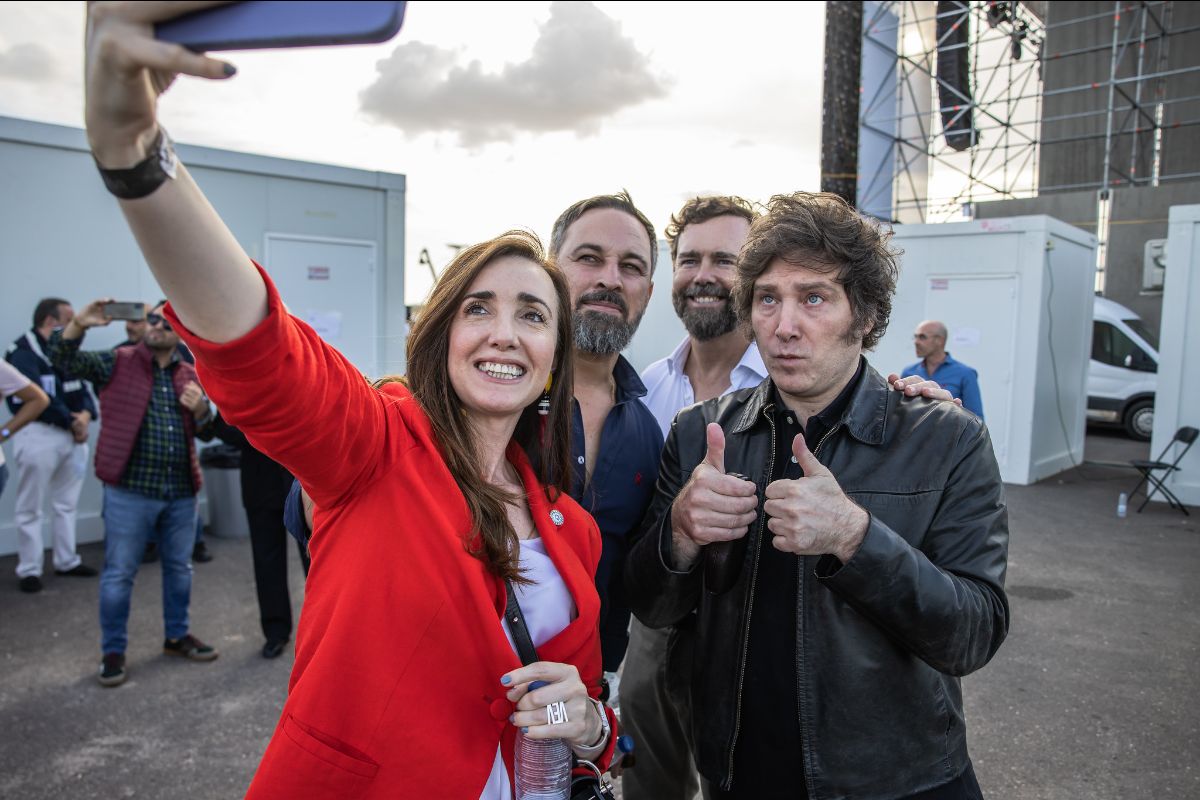 Photo is of a woman taking a selfie of herself and three men. The man furthest right has two thumbs up.