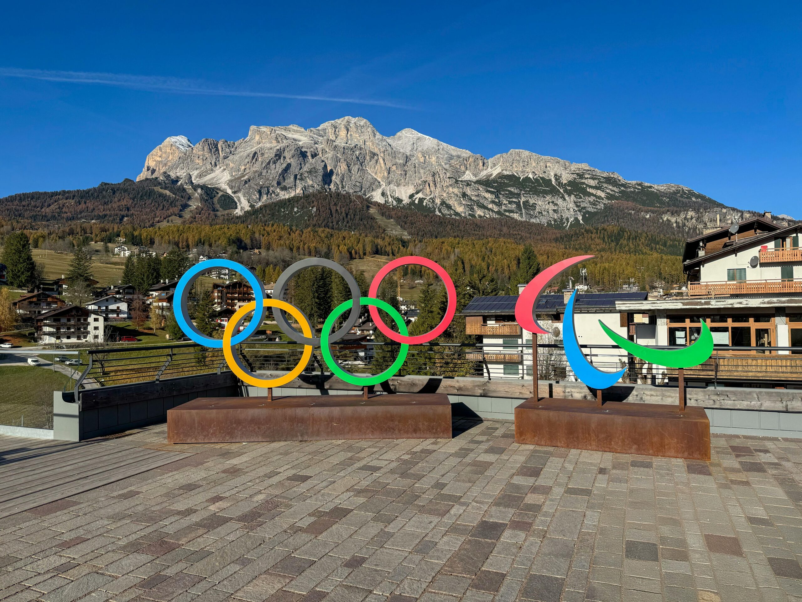 Photo of the Olympic and Paralympic Symbols in Cortina d'Ampezzo with one of the mountains in the background.