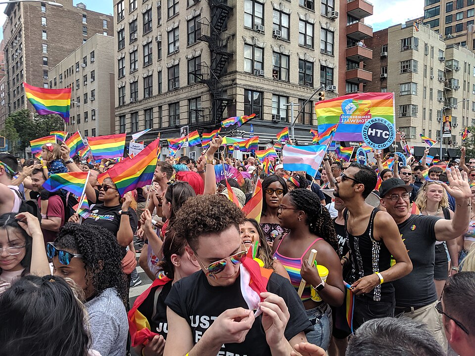 Photo of Stonewall 50 WorldPrice NYC 2019 celebrations with large crowds of people on city streets many waving rainbow pride flags