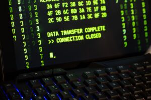 Data transfer complete message displayed on a computer monitor with a keyboard underneath.